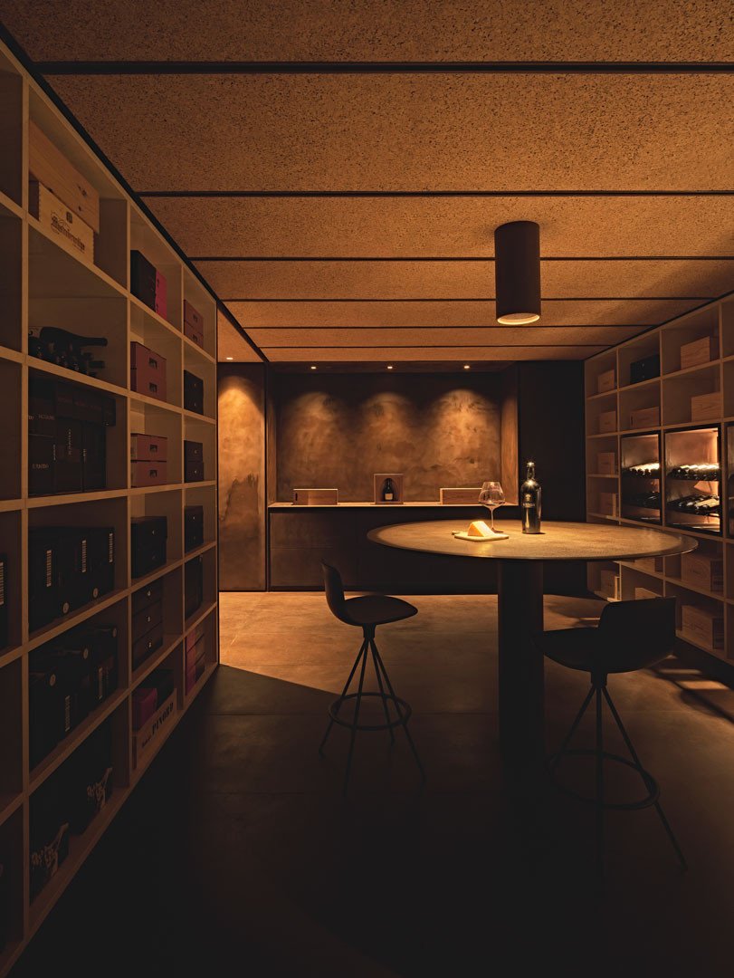 Tinta room with the circular table and the stone niches holding bottles